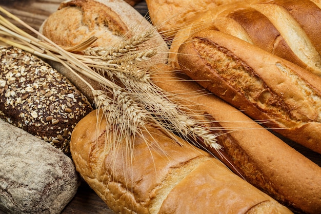 Fresh loaves of bread on wood