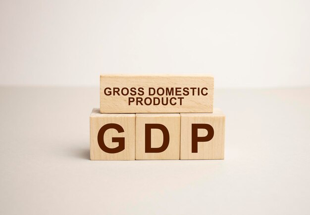 GDP word written on wood block GDP text on wooden table for your desing concept