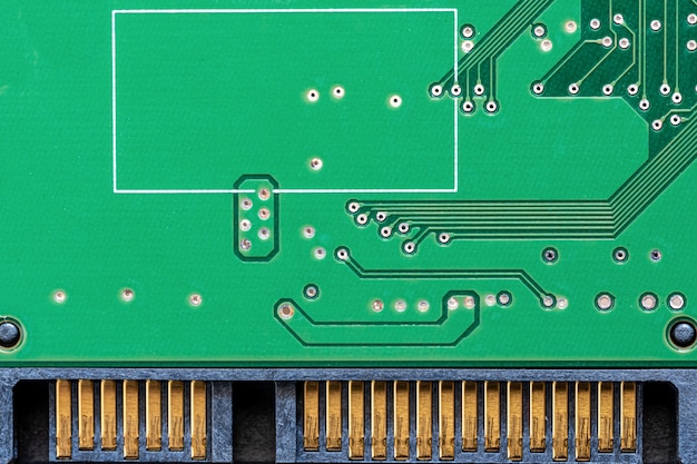 green mechanical hard disk circuit board, local close-up on white background