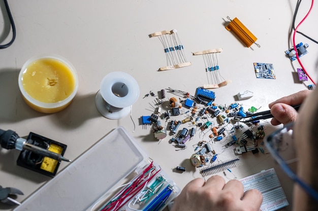 Guy holding electronic parts with his hand