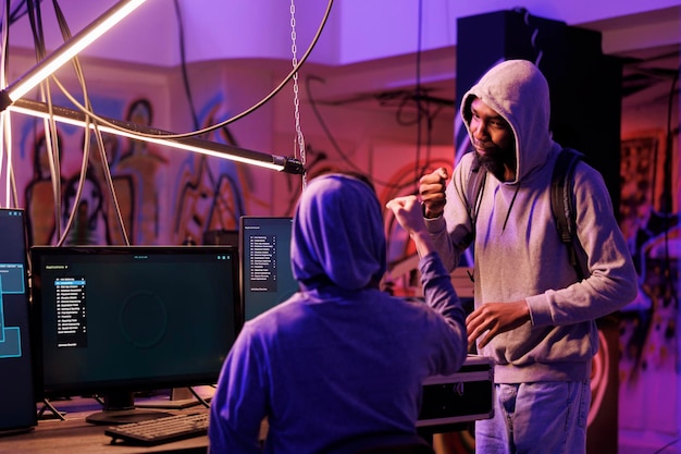 Hacker and crime partner bumping fists
