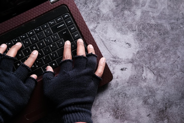 Hacker hand pointing finger on laptop screen