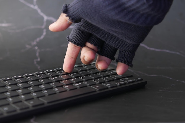 Hacker hand stealing data from laptop top down