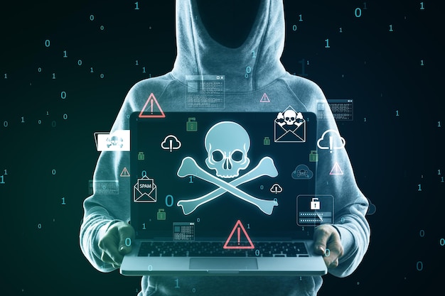 hacker holding laptop with glowing skull hologram on blurry background hacking malware and phishing concept