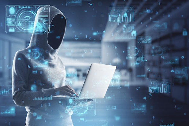 hacker in hoodie using laptop with abstract creative business charts and binary code on blurry office interior background system engineering and digital transformation concept double exposure