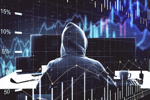 Hacker sitting in office and using computer with chart