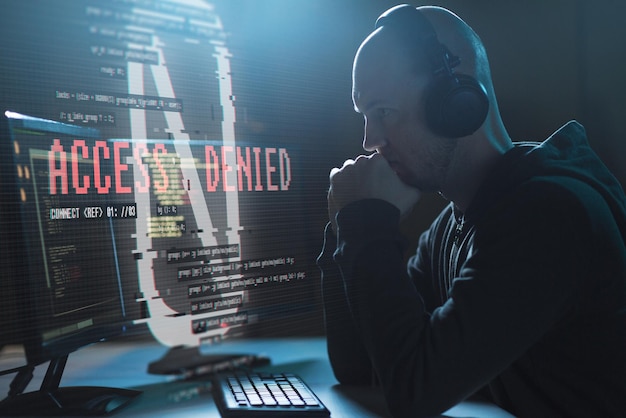 hacker with access denied messages on computer