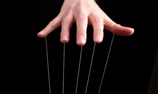 Hand manipulating and controlling smth with strings concept