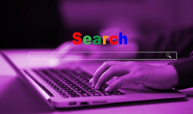 hand type laptop and searching browsing internet data information with blank search bar man's hands are using smartphone and keyboard to searching for information using search console with website