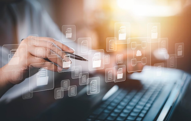 Hand using laptop and touch folder of document Management System online documentation database and process automation to efficiently manage files work knowledge Corporate business technology