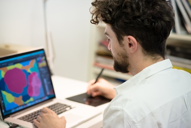 handsome hipster modern man working home using laptop