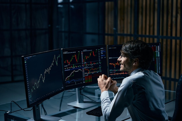 Happy businessman looking at the computer screen