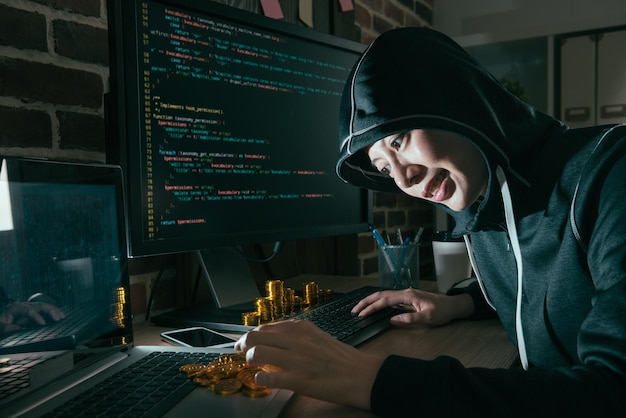 happy young woman hacking global business computer spreading internet virus for getting ransom and count bitcoin gold money happy.
