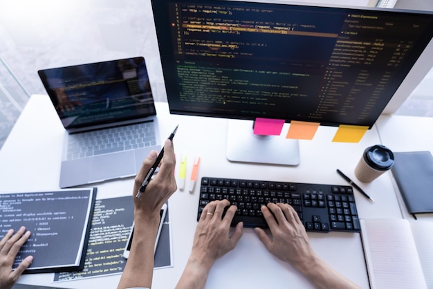 High angle view of hands working with computer at office desk