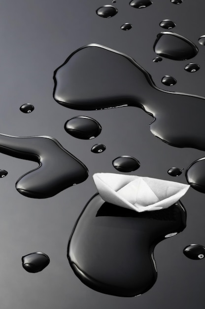 High angle view of paper boat on water against black background