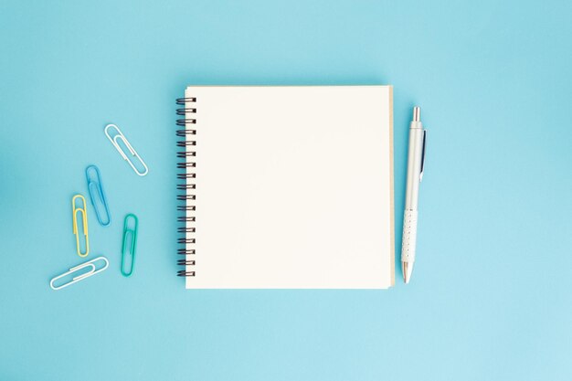 High angle view of pen on book against blue background
