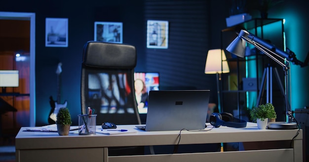 Home office desk in front of smart TV displaying news program broadcasting