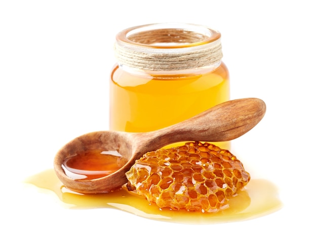 honey with honeycomb and wooden spoon