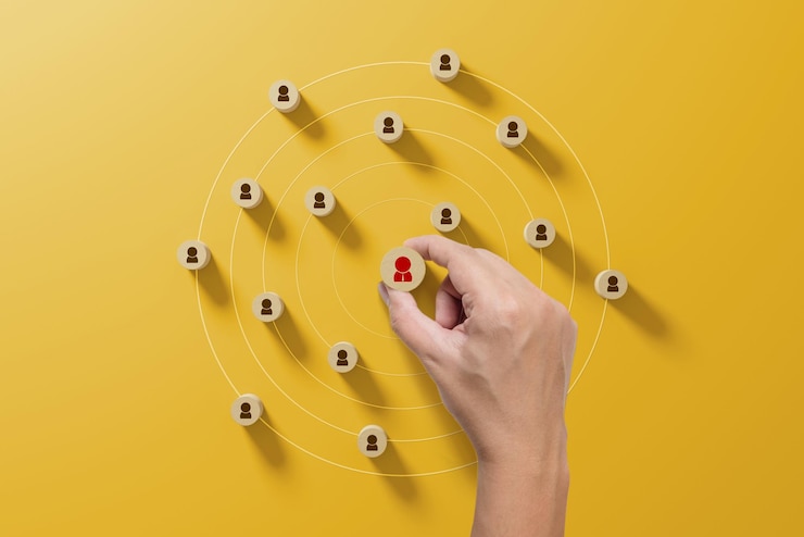 Bild human resource management and recruitment business concept hand holding wood cube with icon people on yellow background