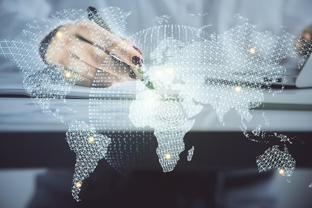 International business hologram over hands taking notes background Concept of success Multi exposure