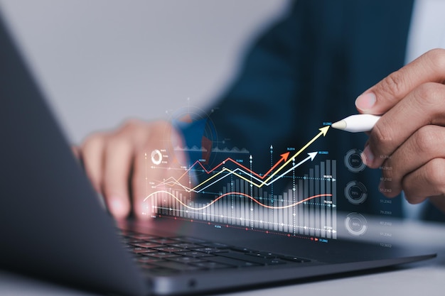 Investment strategy planning Businessman use computer laptop with analyzes financial growth graph for longterm investment Financial goals and global economic business planning