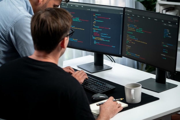 IT developers discussing online software development information on pc screen creating program coding for latest version application on website Concept of brainstorming firmware updated Sellable