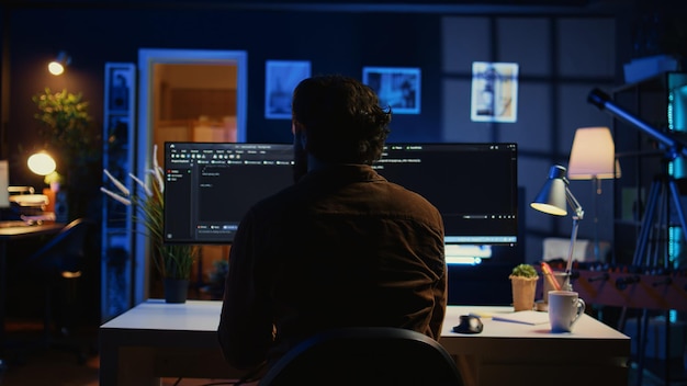 IT specialist in home office enjoying hot beverage while programming