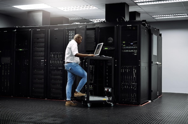 IT support black man or coding on computer in server room for big data network glitch or digital website Code fixing or technician typing on laptop testing UX programming or software development