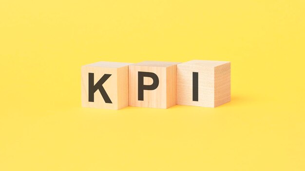 kpi key performance indicator concept kpi text in wooden cube block on table for business planning and measure success target achievement copy space