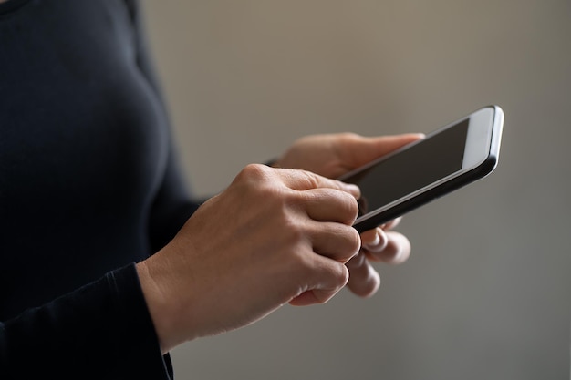 Kvinna använder mobiltelefon (mellansektion)