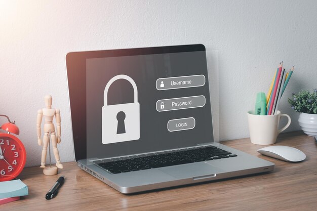 Laptop computer on office desk with login and password on screen display cyber security concept data protection and secured internet accessx9