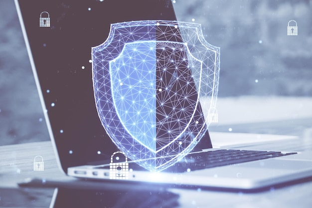 Laptop with glowing polygonal shield hologram