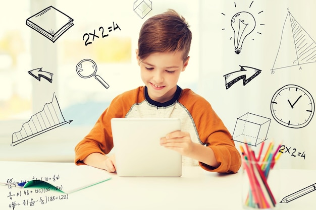 leisure, children, education, technology and people concept - smiling boy with tablet pc computer and notebook at home over mathematical doodles