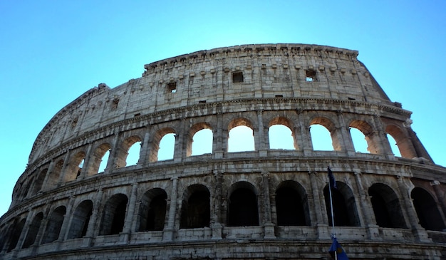 low angle view of coliseum against clear blue sky