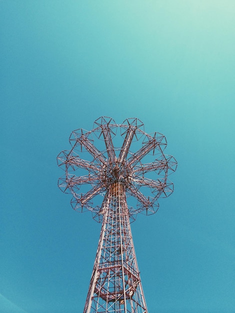 Low angle view of parachute jump ride in coney island against clear sky