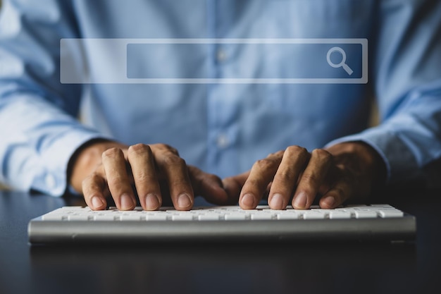 Male hand typing on computer keyboard searching