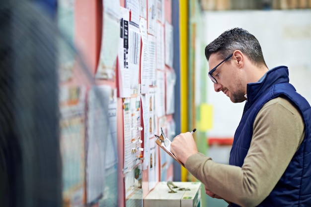 Man business and board for checking calendar or schedule for shipping details supplier information and warehouse Male person clipboard and notes for orders or inventory poster and distribution