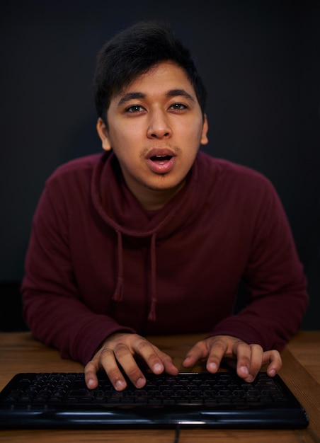 Man face and keyboard for coding programmer and information technology with video game or software development Internet computer programming and portrait gamer or developer for cyber security