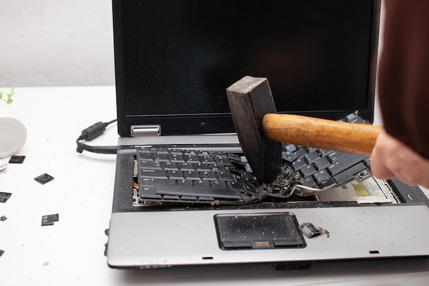 man office worker smashed a laptop destroyed a computer anger hatred irritation error brake malfunction does not want work bad emotions depression not preserved close up
