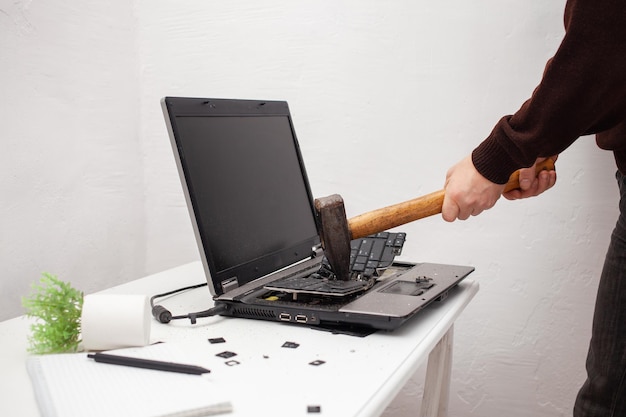 man office worker smashed a laptop destroyed a computer anger hatred irritation error brake malfunction does not want work bad emotions depression not preserved nut