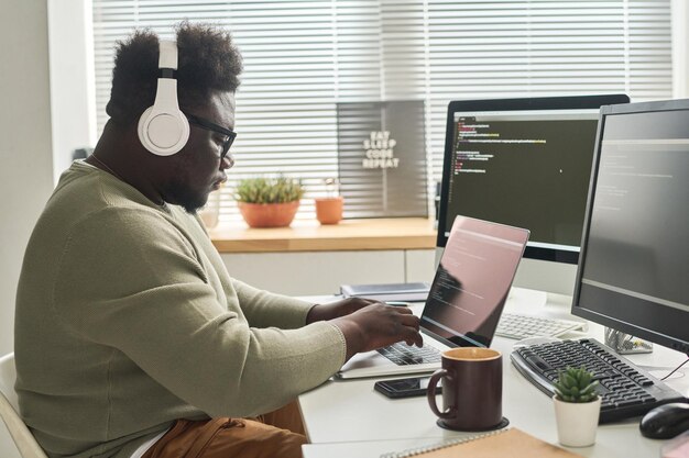 Man programming new apps on laptop