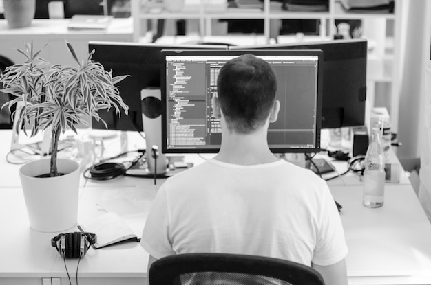 Man som arbetar på kontor, sedd bakifrån