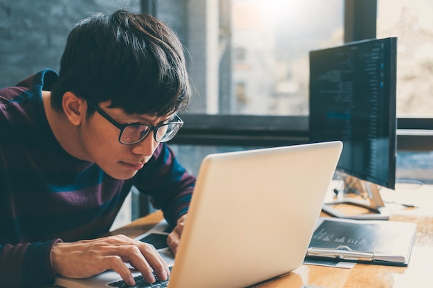 Man using laptop while sitting at table