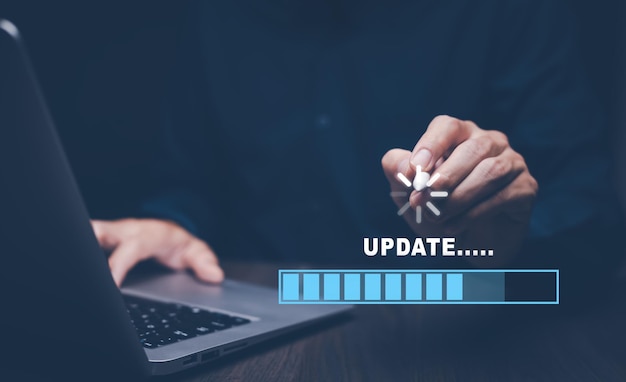 man using laptop with update software computer program upgrade business technology internet update on virtual screen internet and technology concept loading bar with installing the update