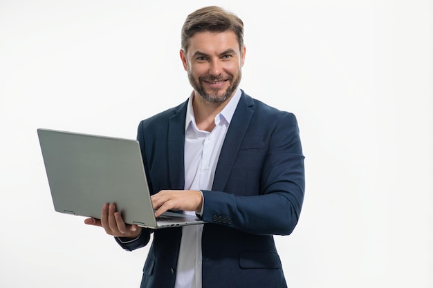 Man working on laptop in studio man in suit checking email on laptop writing message in social