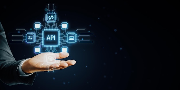 Mans hand holding digital API icons in neon blue lines on dark background symbolizing modern technology and network concept
