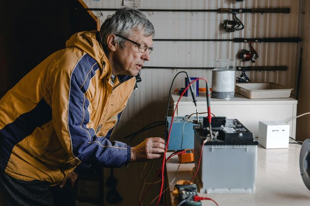 mechanic doing service on electric car battery