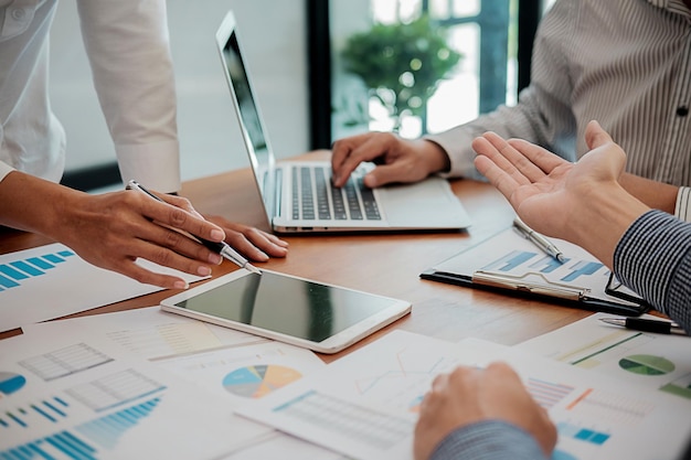 Midsection of man with colleagues working at office
