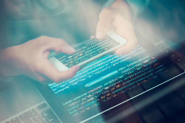 Midsection of person using digital tablet and laptop