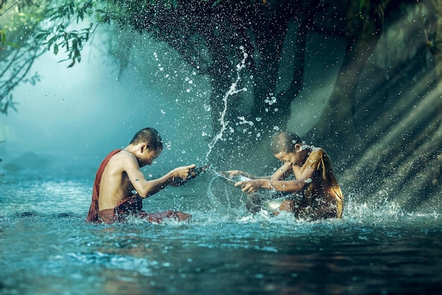 monks splashing water in river
